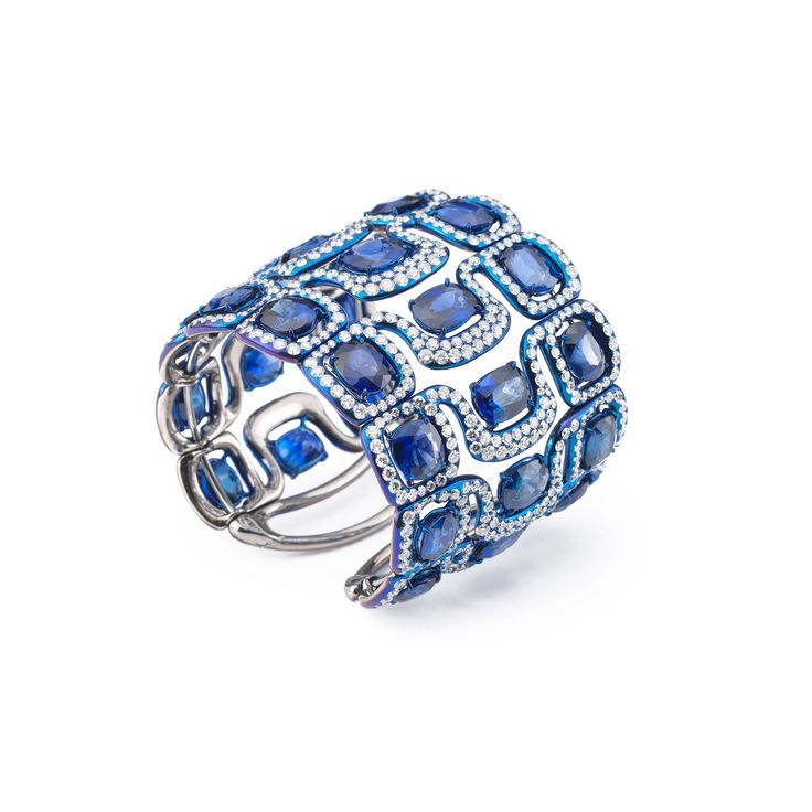 A large blued titanium cuff set with diamonds and sapphires created by Glenn Spi...