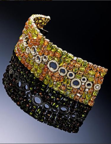 A peridot, citrine and diamond bracelet in 18k, Bulgari 2009 designed as a wide ...