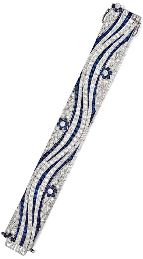 PLATINUM, SAPPHIRE AND DIAMOND BRACELET, CIRCA 1935 The wide articulated band of...