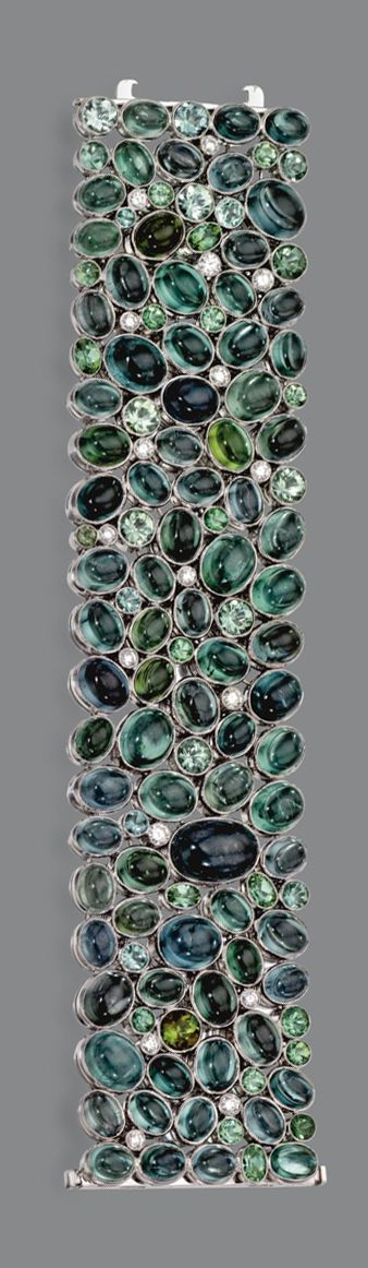 TOURMALINE AND DIAMOND BRACELET. The wide band clustered with multi-colored roun...