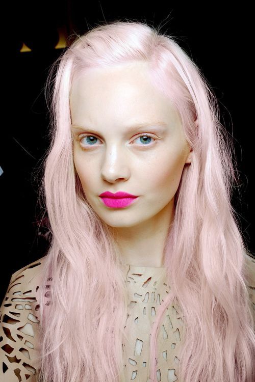 Bright pink long hair side part with bright pink lips.