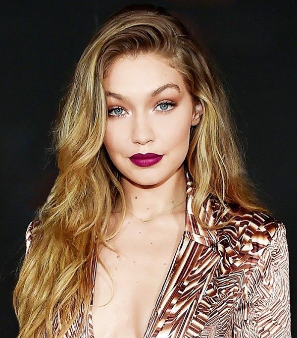 Gigi Hadid deep side part and bold berry lips make for a bombshell beauty look. ...