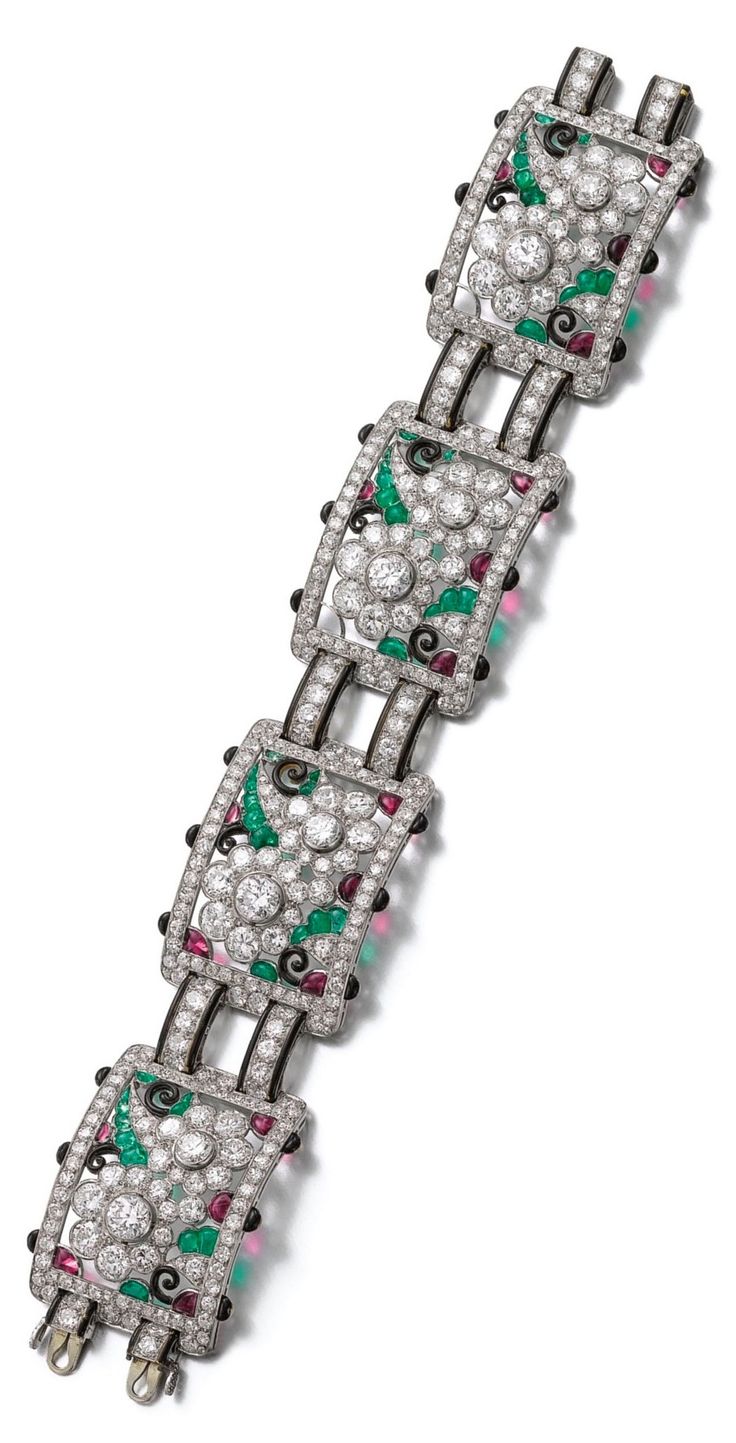 An Art Deco gem set, enamel and diamond bracelet, 1930s. Designed as a series of...