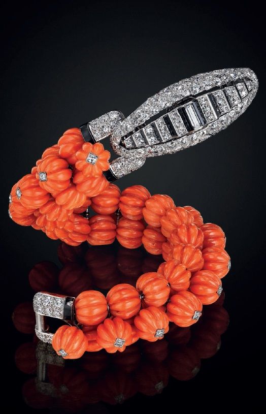 CARTIER An art deco carved coral, onyx, diamond, and platinum bracelet, by Carti...
