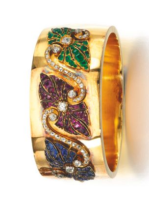 GOLD AND GEM SET BANGLE, LATE 19TH CENTURY The hinged bangle set to the front wi...