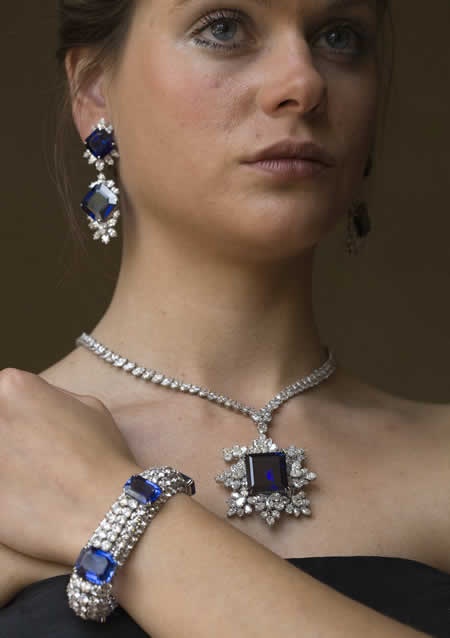 Model displays sapphires and diamonds bracelet, necklace and earrings made by Ha...