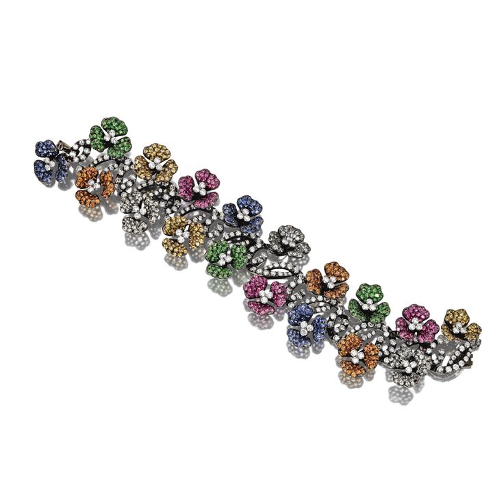 MULTI-COLORED SAPPHIRE AND DIAMOND FLOWER BRACELET Designed as two rows of bloss...