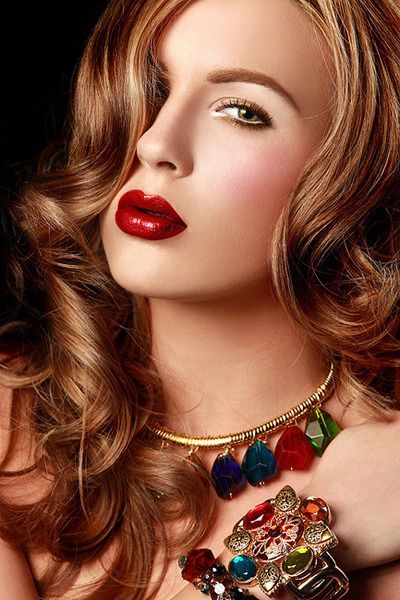 vintage long hairstyle with waves, statement necklace and dark red lips.