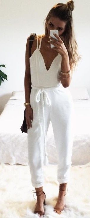 women's fashion | White jumpsuit, heels, handbag and a messy bun