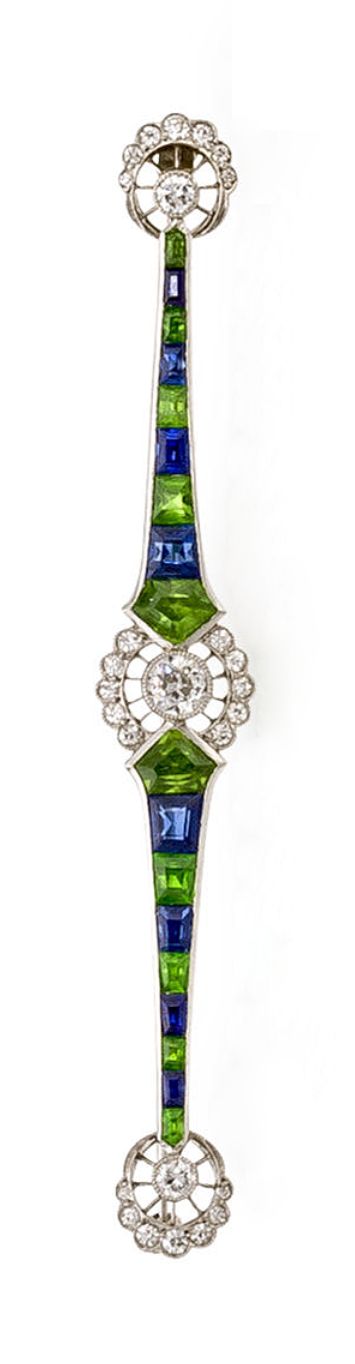 A Belle Epoque diamond, demantoid garnet & sapphire brooch, Marcus & Co, ca 1915...