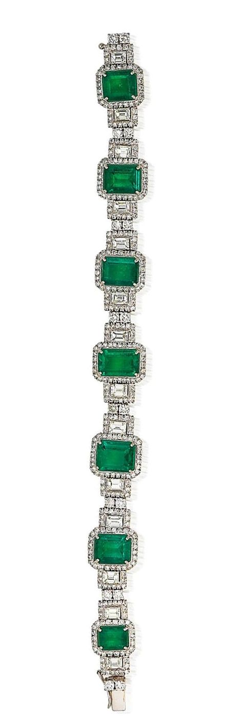 An emerald and diamond bracelet The articulated bracelet formed as a graduated s...