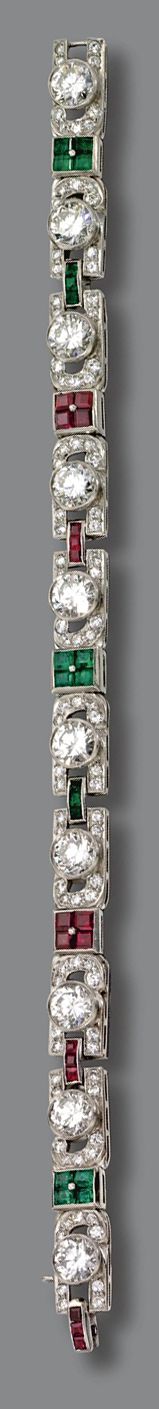 DIAMOND, RUBY AND EMERALD BRACELET, CIRCA 1930. Set with 10 round diamonds weigh...