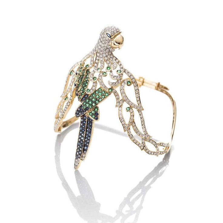 Our kind of #parrot doesn't talk back and is made with #emeralds, #sapphires and...