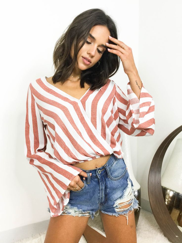 Hop on the stripe trend with the Lucy Striped Bell Sleeve Top. Featuring a surpl...