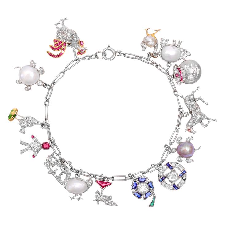 Art Deco charm bracelet composed of fifteen gem-set charms attached to an oval l...