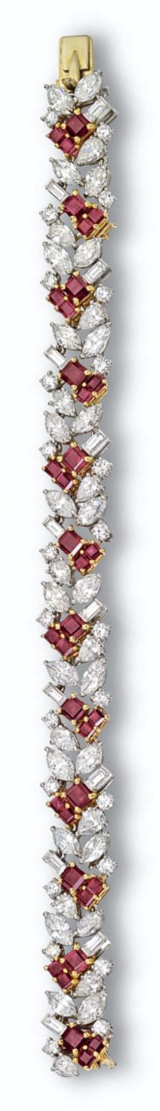 RUBY AND DIAMOND BRACELET, CARTIER. The stylized foliate motif set with 12 pear-...
