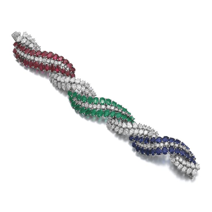 Ruby, emerald, sapphire and diamond bracelet Of twist design, set with oval and ...