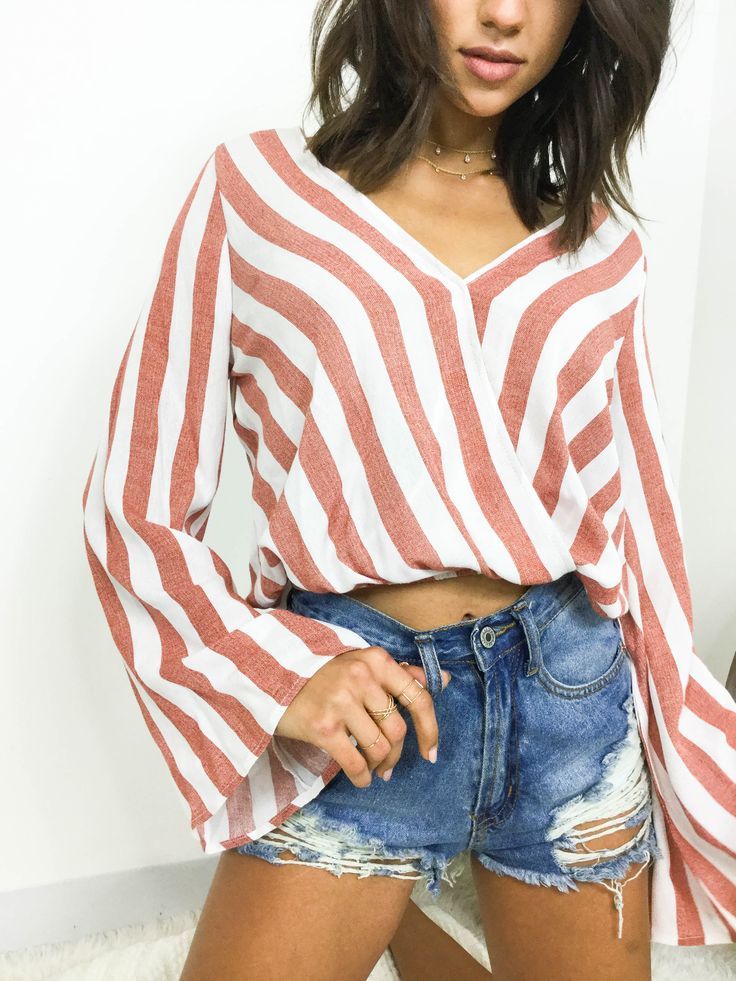 Hop on the stripe trend with the Lucy Striped Bell Sleeve Top. Featuring a surpl...