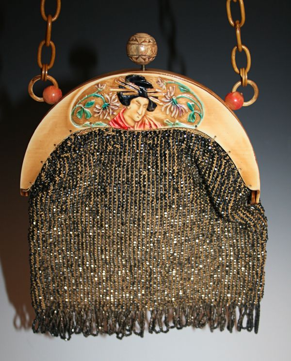 This celluloid purse has a depiction of a geisha’s head very similar to the us...