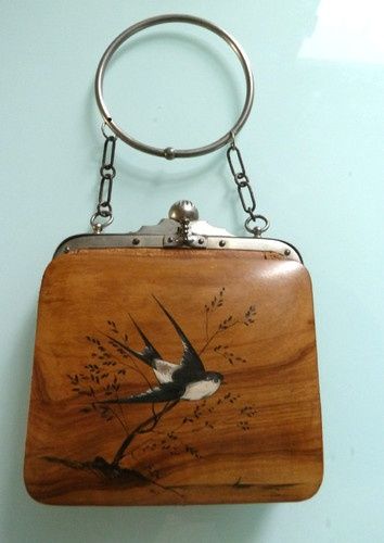 Wooden purse with barn swallow design.