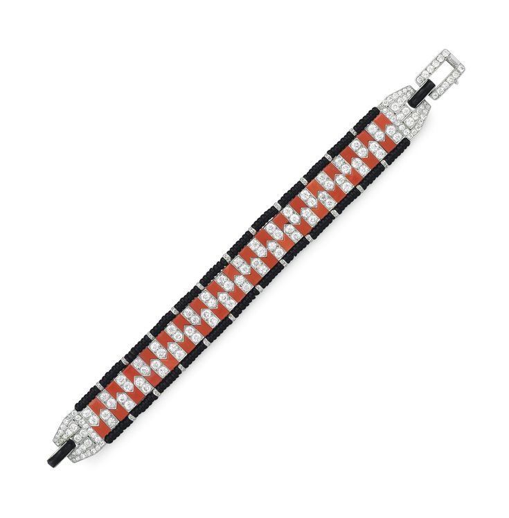 AN ART DECO CORAL, ONYX AND DIAMOND BRACELET, BY CARTIER Designed as a flexible ...