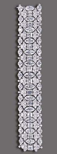 AN ELEGANT DIAMOND BRACELET, BY HARRY WINSTON The highly flexible wide band, com...