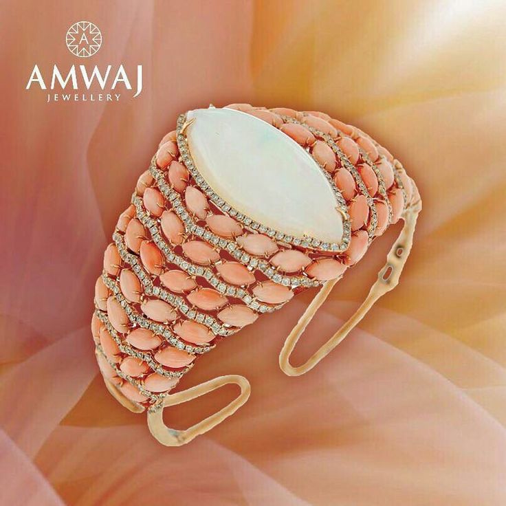 A bangle with a refreshing summer combination of coral and opal is simply outsta...