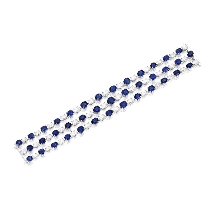 PLATINUM, SAPPHIRE AND DIAMOND BRACELET Composed of three rows set with 40 oval-...