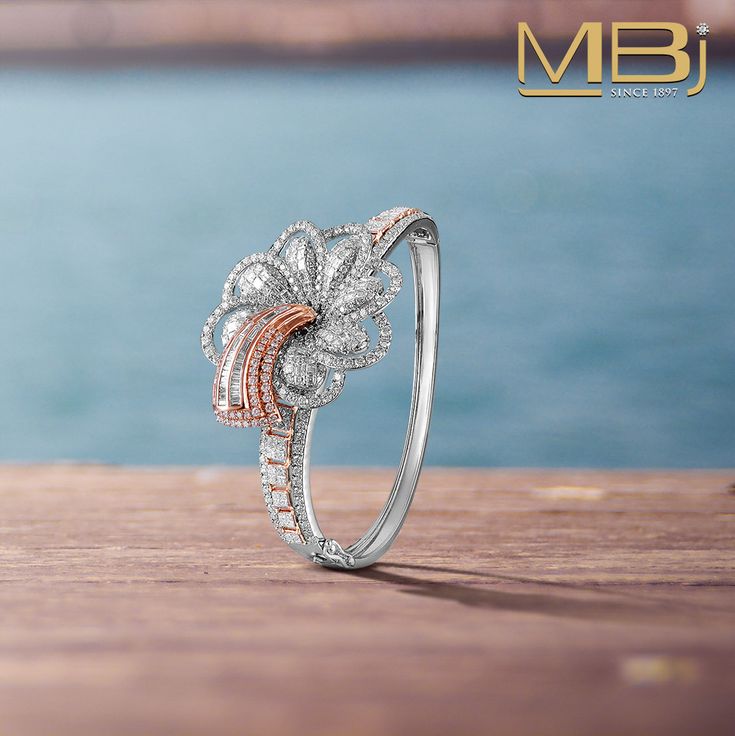 Diamond bracelet with flower motif along with round & baguette shaped diamonds.