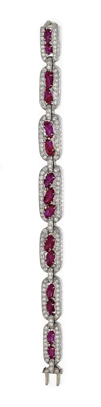 DIAMOND AND CARVED RUBY BRACELET AND RING, CIRCA 1930. The bracelet set with old...