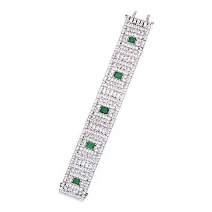 Platinum, Emerald and Diamond Bracelet, France The wide band of geometric design...