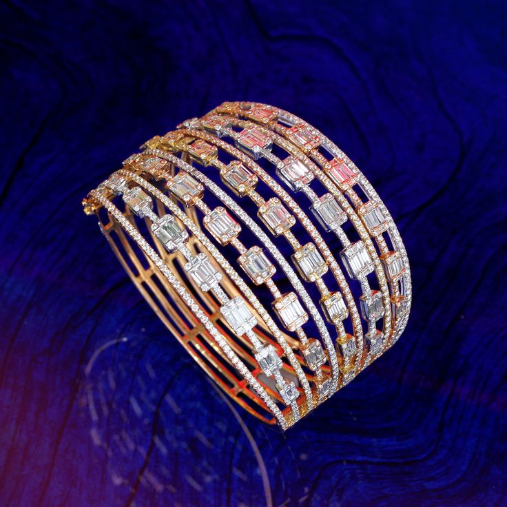 Contemporary tri-toned diamond bangle with artful alternations of baguette and r...