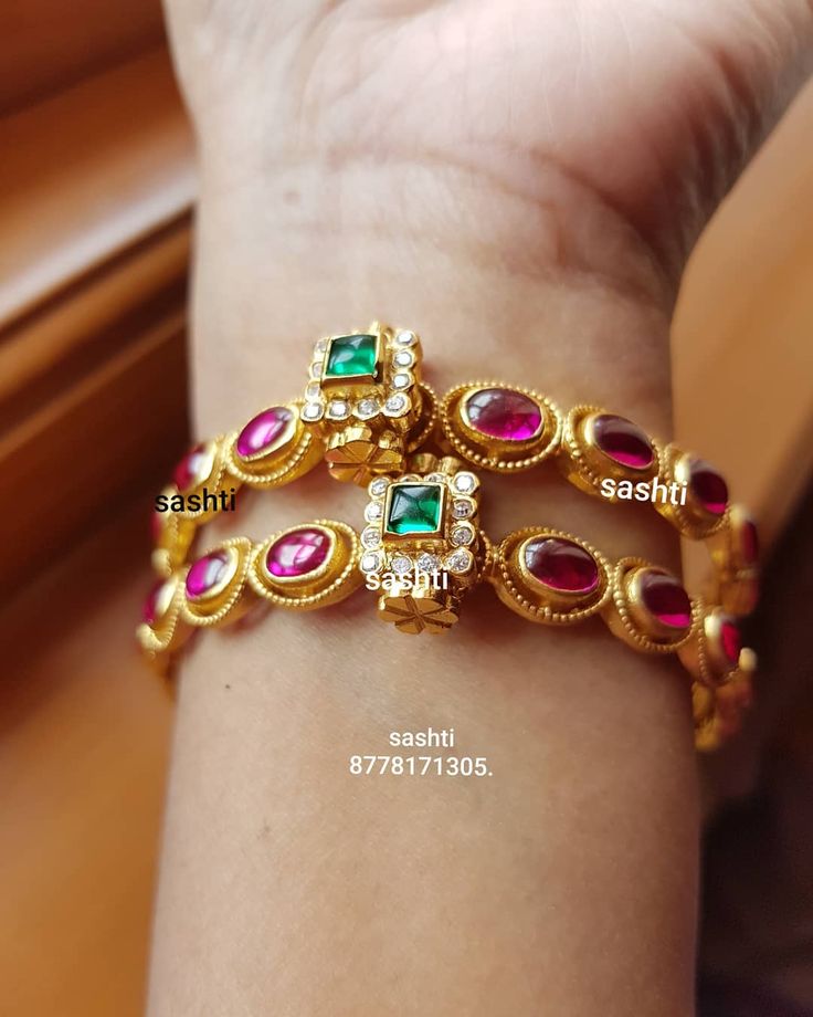 Beautiful silver bangle with gold polish. Bangle studded with rubies and emerald...