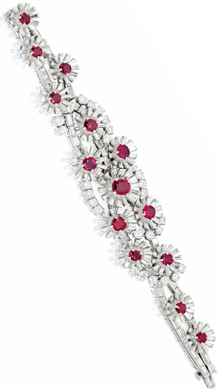 RUBY AND DIAMOND BRACELET, C.1950 Of floral design, the flowers composed of four...