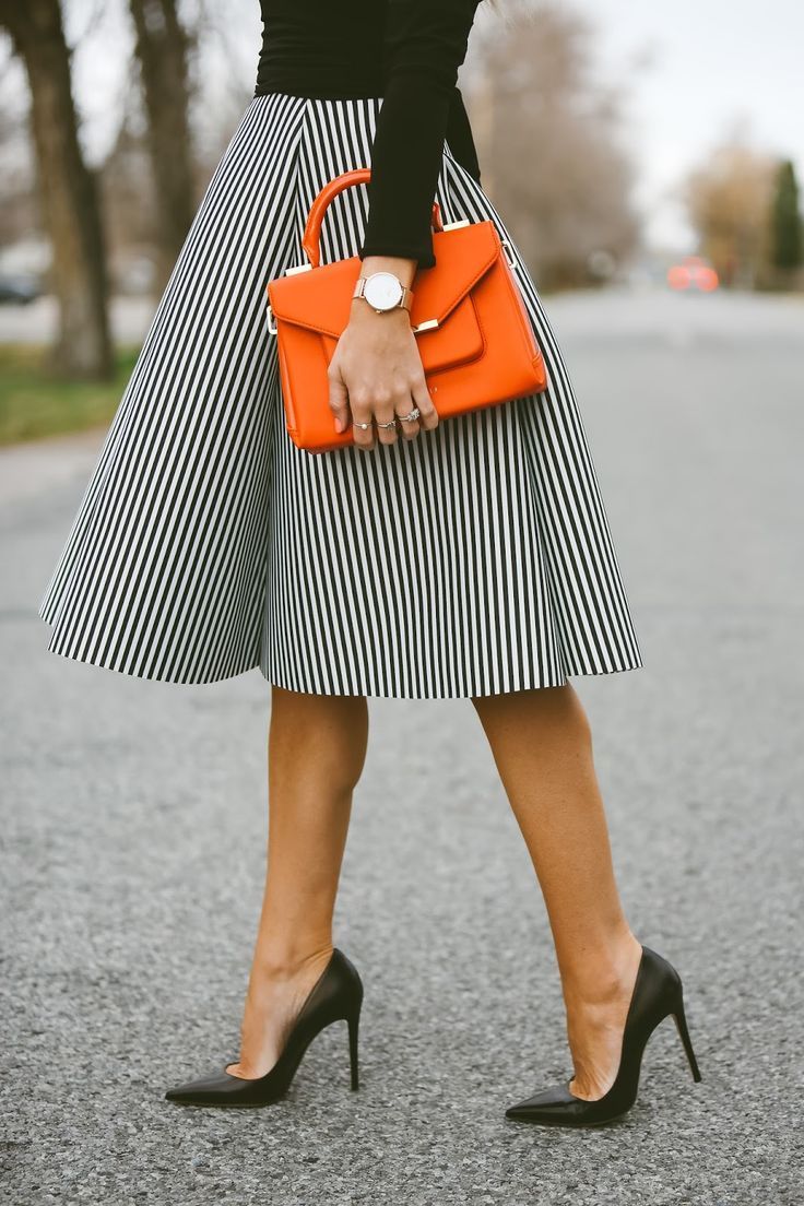 Pin stripped skirt and a pop of color with an orange accessory ❤️