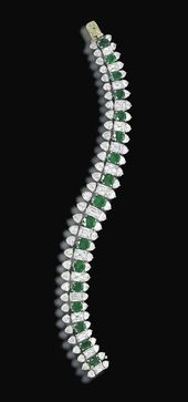 AN EMERALD AND DIAMOND BRACELET, BY HARRY WINSTON Designed as a series of oval-s...