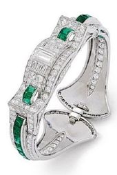 An Art Deco Emerald, Diamond and Platinum Bangle Bracelet, Oscar Heyman, circa 1...
