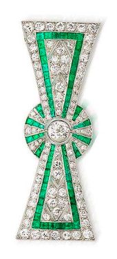 An art deco diamond and emerald bow brooch, circa 1925 The stylised ribbon bow w...