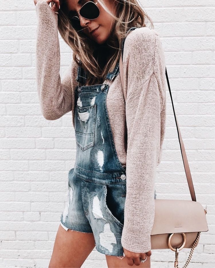 Denim overalls with blush top.